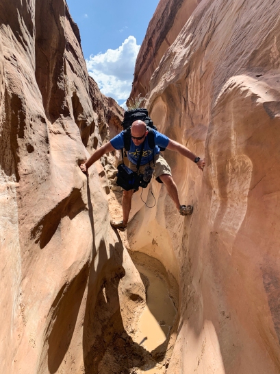 Image of man climbing through canyon